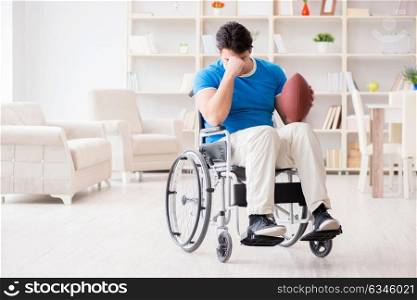 Young man american football player recovering on wheelchair