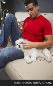 Young man and a dog on a couch