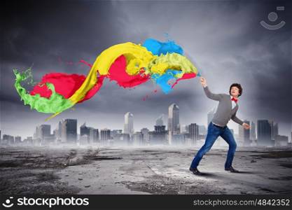 Young man and colour splash. Young man with a splash coloured like a rainbow