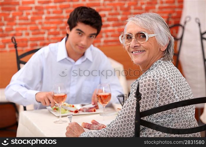 Young man and elderly woman in a restaurant