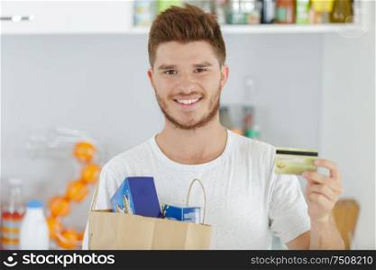 young man and grocery shopping concept
