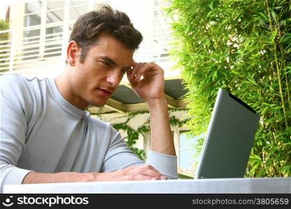 young man and laptop at the home