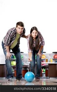 Young man and the girl in bowling