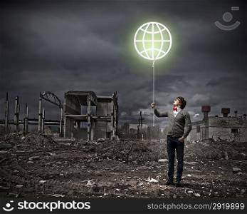 Young man and the symbol of our planet