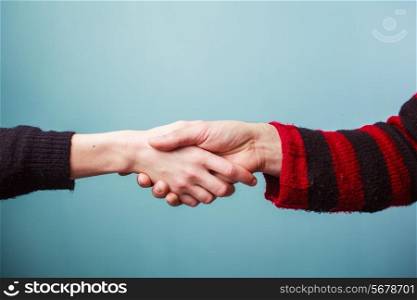 Young man and woman are shaking hands
