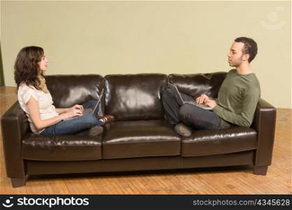 Young Man and Woman Computing on Couch