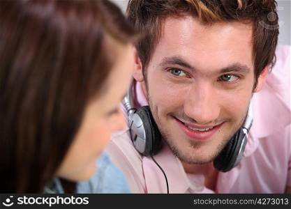 young man and woman listening music at home