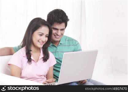 Young man and woman working on the laptop