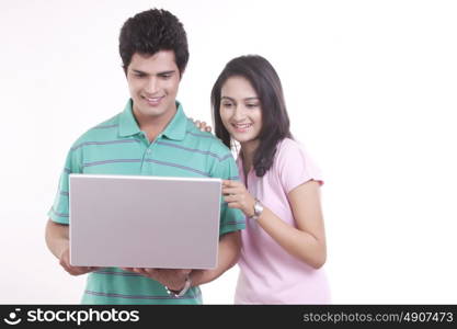 Young man and woman working on the laptop