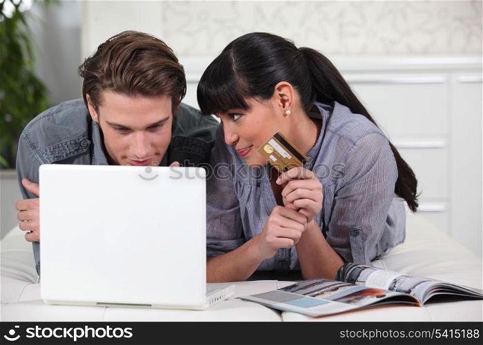 Young man and young woman making online purchases