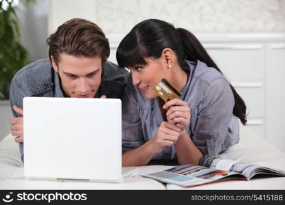 Young man and young woman making online purchases