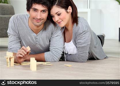 Young man and young woman playing dominoes