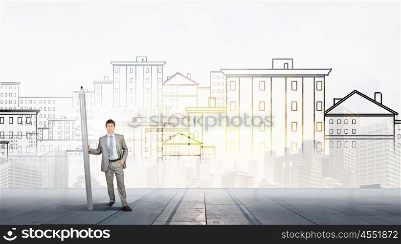 Young man architecture designer with huge pencil. Construction designer