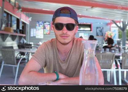 young man at bar terrace during summer