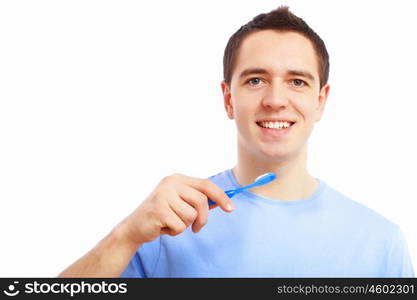 Young man at home brushing teeth in the morning