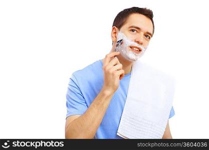 Young man at home shaving himself in the morning