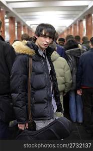 Young man at metro station, focus on zip fastener