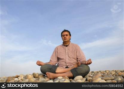 young man at the beach in meditation
