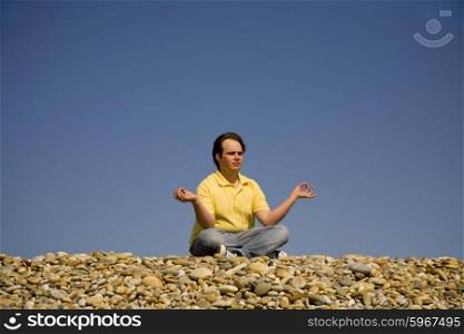 young man at the beach in meditation
