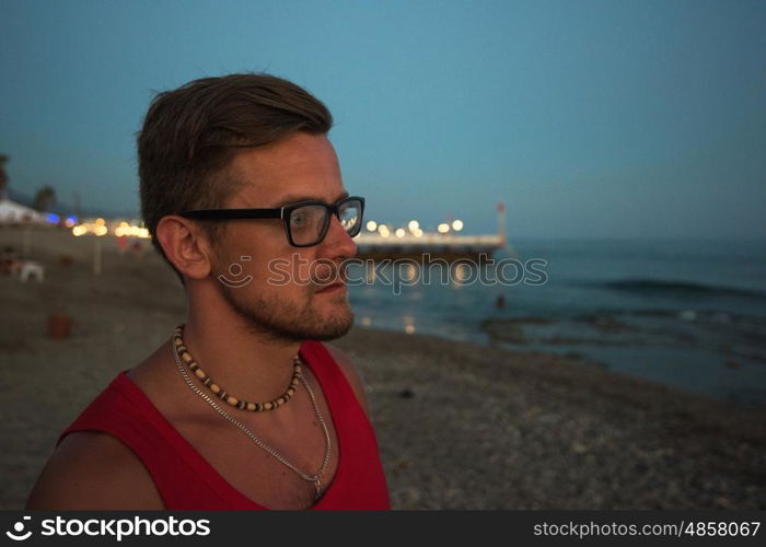 Young man at the evening sea, on the beach at Alania, Turkey