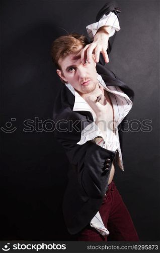 young man attacking with knife on black background