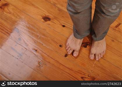 young man bare feet on wooden floor background