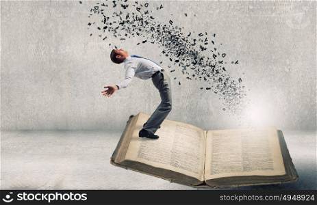 Young man benting to evade characters flying from book. Businessman evades ideas