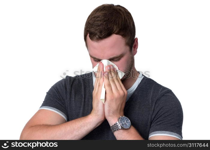 Young Man Blowing Nose into a tissue