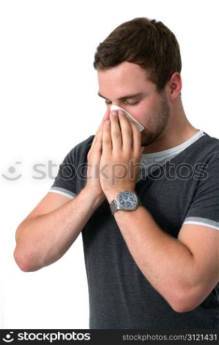 Young Man Blowing Nose into a tissue