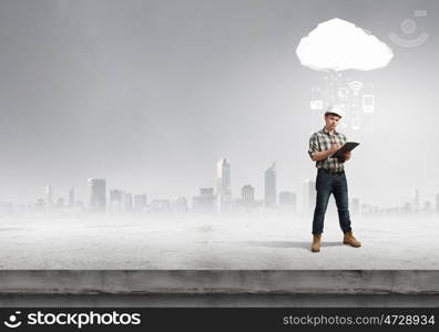 Young man builder looking thoughtfully at construction project. concept. Builder has an idea