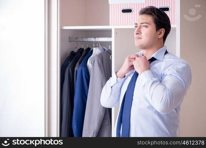 Young man businessman getting dressed for work