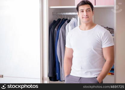 Young man businessman getting dressed for work