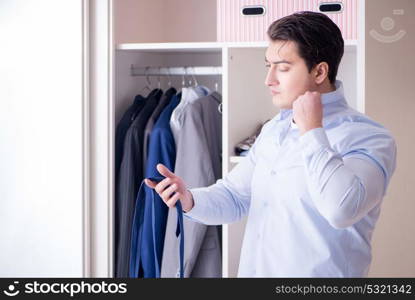 Young man businessman getting dressed for work