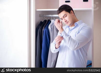 Young man businessman getting dressed for work