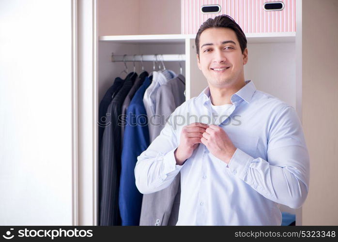 Young man businessman getting dressed for work