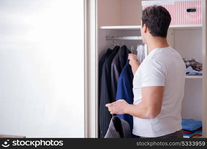 Young man businessman getting dressed for work