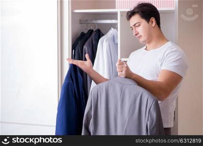 Young man businessman getting dressed for work