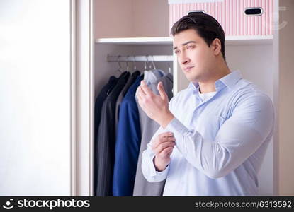 Young man businessman getting dressed for work