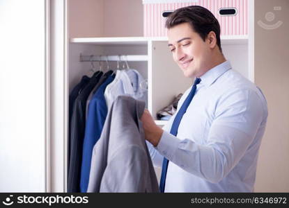 Young man businessman getting dressed for work