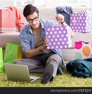 Young man buying clothing online and running blog. The young man buying clothing online and running blog