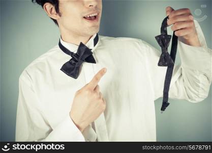 Young man can&rsquo;t tie a bow tie so he choses a clip-on instead