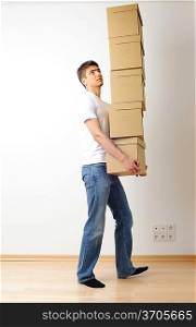 Young man carrying a stack of boxes