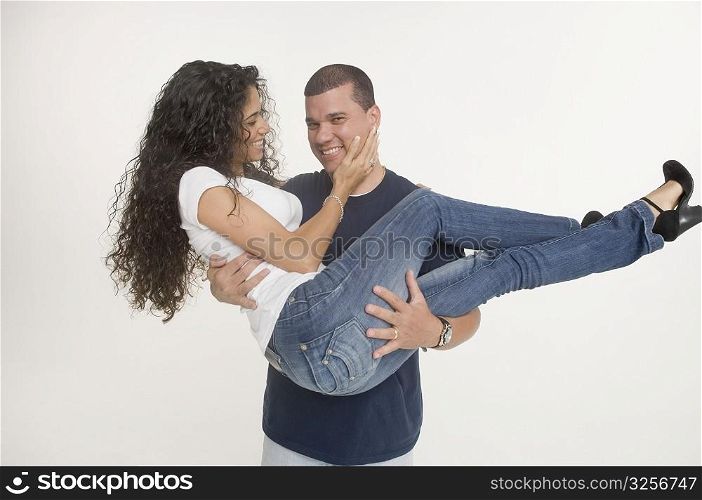 Young man carrying fiancee