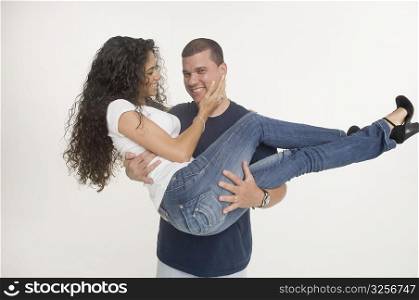 Young man carrying fiancee