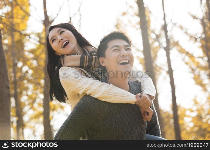 Young man carrying his girlfriend