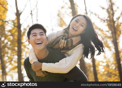 Young man carrying his girlfriend