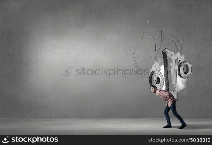 Young man carrying percent sign on his back. My interest is rather big