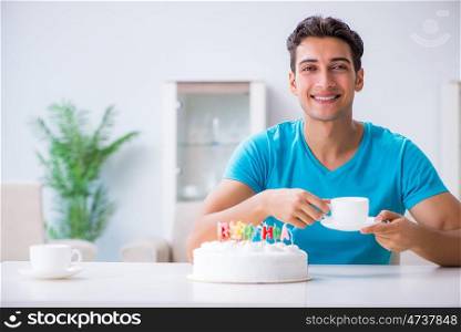 Young man celebrating birthday alone at home