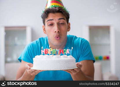 Young man celebrating birthday alone at home