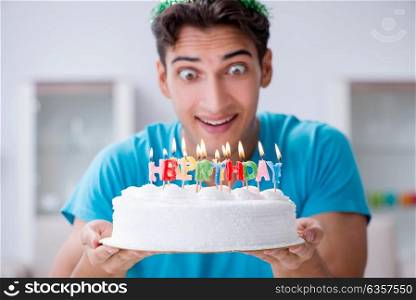 Young man celebrating birthday alone at home